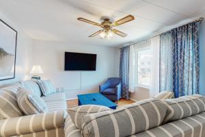 a living room with two couches and a ceiling fan at Exeter Road Daydream in Ocean City