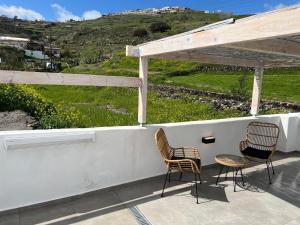 two chairs and a table on a porch with a view at Episkopi Estate Cycladic Villas in Éxo Goniá +67 photos