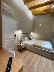 a bedroom with a bed in a room with a desk at Arial Penthouse Suites in Vlorë