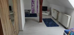 a hallway with blue rugs in a room at Pension Bärbel in Bernburg