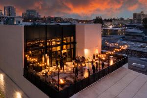 a view of a building with people on the balcony at night at Kissel Uptown Oakland, in the Unbound Collection by Hyatt in Oakland