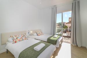 a bedroom with two beds and a balcony at LXR Bellavista 3Hab. Next to Sea in Fuengirola