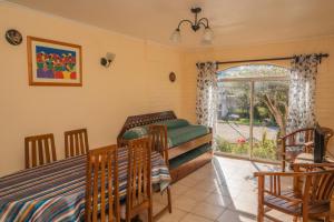 a living room with a bed and a window at Cabañas Villa Los Platanos in La Serena