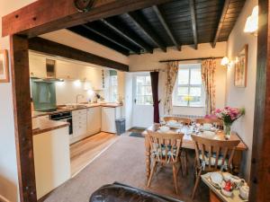 a kitchen and dining room with a table and chairs at Ghyll Cottage in Rosedale Abbey