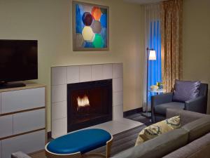 a living room with a couch and a fireplace at Sonesta ES Suites Colorado Springs in Colorado Springs