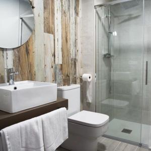 uma casa de banho com um lavatório, um WC e um chuveiro em Hotel Rural Covarrubias em Covarrubias