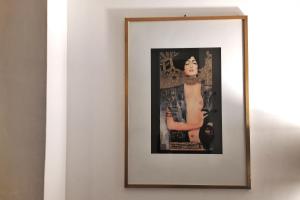 a framed picture of a woman on a wall at Arezzo Charming Apartment in Arezzo