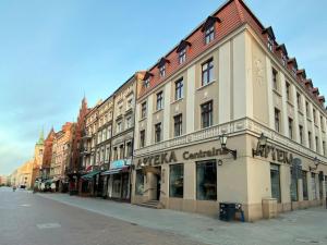 a row of buildings on a city street at 1st Floor Apartment in Toruń