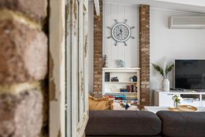 sala de estar con sofá y reloj en la pared en Dundas Escape en Rye