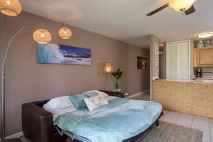 a bedroom with a bed and a kitchen at Beach Cozy North Shore Turtle Bay Condo in Kahuku