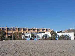 a building on the beach in front of a building at Beautiful Apartment in Almer a with Swimming Pool in Playas de Vera
