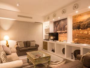 a living room with a couch and a tv at Monte Alto Agroturismo in Campo Maior