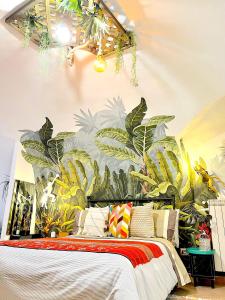 a bedroom with a mural of plants on the wall at Apartment Napoli in Naples