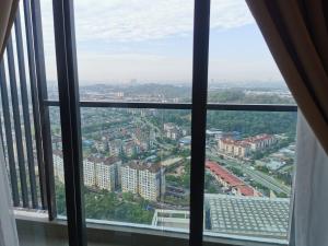 a view of a city from a window at Apple Home 1 @ Menara Simfoni/Symphony Tower C180/Cheras/Mines/Balakong/Kuala Lumpur in Seri Kembangan