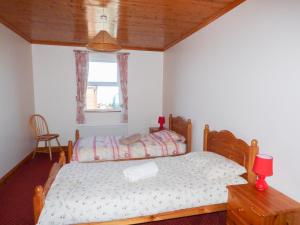 a bedroom with a bed and a window at Seaview Cottage in Ballyvaughan