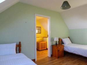 a bedroom with two beds and a door to a room at Sugarbush in Eyeries