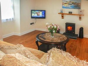a living room with a coffee table and a fireplace at Nellie's Farmhouse in Bantry