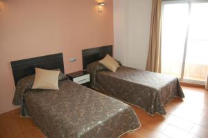 Postel nebo postele na pokoji v ubytování Hotel Almoradi