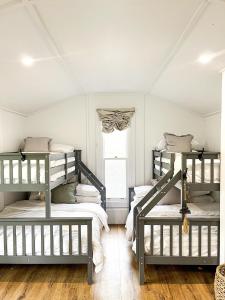 two bunk beds in a room with a window at Waukivory Estate - The Cottage 
