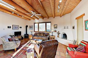 a living room with a couch and a fireplace at Casa Allis Taos in El Prado