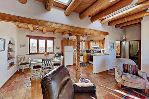 a living room with a couch and a table and a kitchen at Casa Allis Taos in El Prado