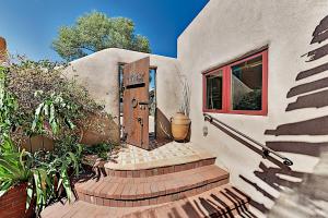 a front door of a house with stairs and plants at Reposada Unit 1 in Santa Fe