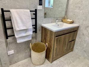 a bathroom with a sink and a mirror at Auckland Central Motel in Auckland