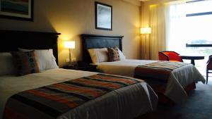 Rúm í herbergi á Carnaval Hotel Casino