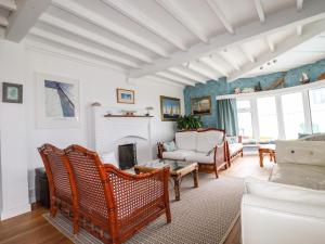 a living room with a couch and a fireplace at Blue Bay Beach House in Newquay