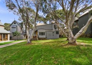 a house with two trees in a yard at Seadog in Dinner Plain