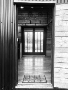 an open door to a room with a door sidx sidx sidx at The Water Shack - Amazing tiny house retreat in Woodbridge