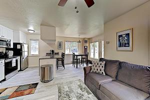a living room with a couch and a kitchen at Homestake Haven 366 in Park City