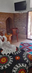 a living room with a swan on a bed with a fireplace at Caravan Sarai in Khiva