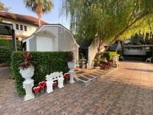 a house with a garden with red bows on benches at Kurina Hotel in Bangkok +11 photos