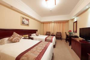 Voodi või voodid majutusasutuse Sanyu Hotel toas