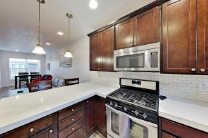 a kitchen with a stove and a microwave at Nevis at Newpark Unit 4 in Park City