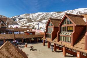 a ski lodge with a snow covered mountain in the background at Mountain Village Lodge 221 in Park City