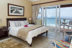 a bedroom with a bed and a view of the ocean at Sea View 3 bedrooms Villa in Brenton On The Rocks in Brenton-on-Sea
