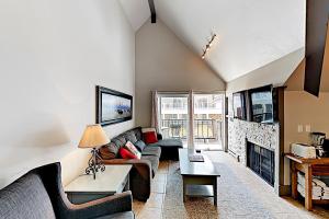 a living room with a couch and a fireplace at Lodge at Mountain Village #306 in Park City