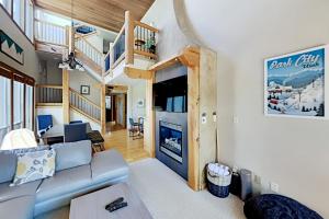 a living room with a couch and a staircase at Three Kings Haven 194 in Park City