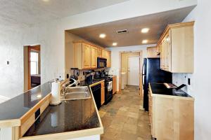a kitchen with wooden cabinets and a black counter top at Redstone Retreat Unit A in Park City