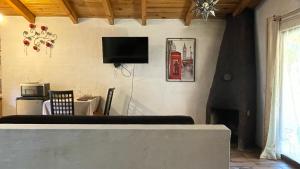 sala de estar con TV en la pared en Cabañas Yasmina, en Mazamitla