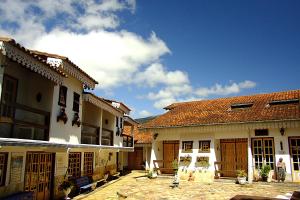 a group of buildings with a blue sky in the background at Pouso das Gerais in Tiradentes
