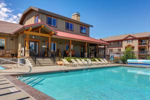 a house with a swimming pool in front of a house at Bobsled Haven in Park City