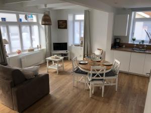 a living room with a table and a couch at Gîte Graziella in Wissant