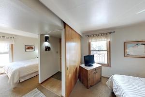 a bedroom with a bed and a tv on a dresser at Ciclo Grande 202B in Santa Fe