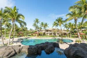 a pool at a resort with palm trees at Mauna Lani Resort 1401 in Waikoloa