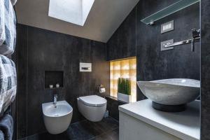 a bathroom with a sink and a toilet at Loft on 1236 in Ortisei