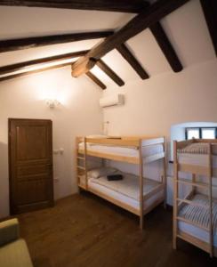 a room with two bunk beds in a room at Hostel Škrla in Divača