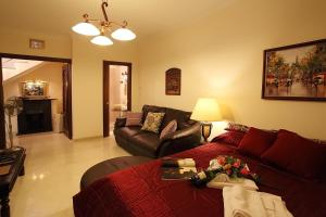 a living room with a couch and a living room with at Le Petit Palais Villa in Plesio